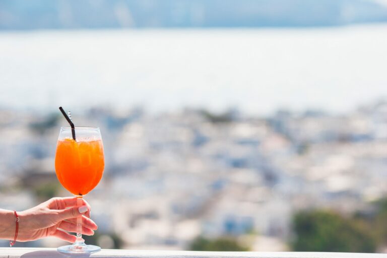 Closeup glass with alcohol drink background in beautiful old Mykonos