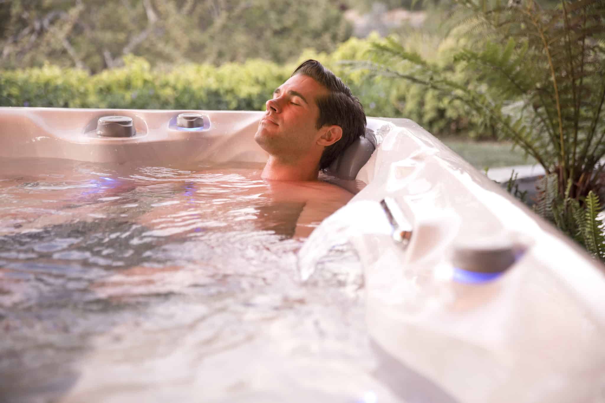 Man soaking in hot tub.