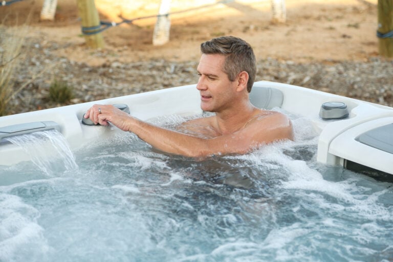 Man experiencing the hot tub benefits of his Sundance Spa