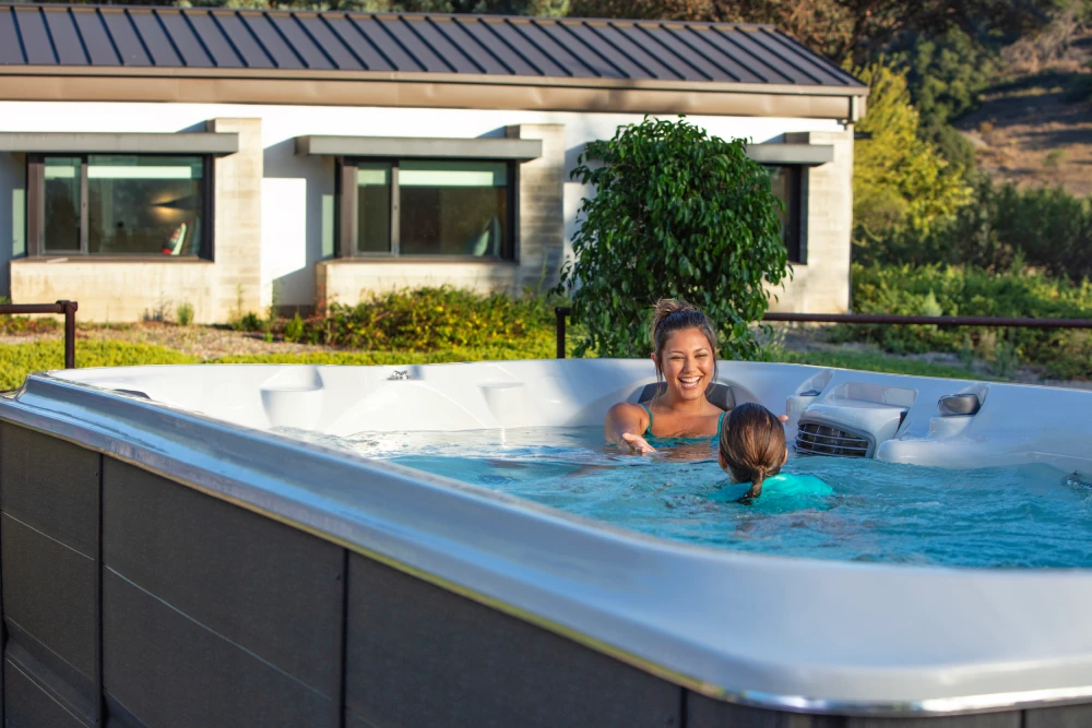 mother and daughter playing in their Jacuzzi swim spa
