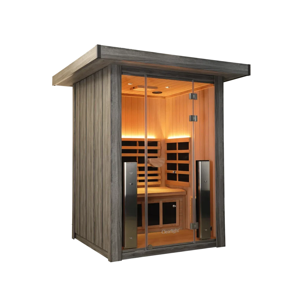 Wooden sauna cabin with glass door, warm interior lighting, benches, and heater visible inside.