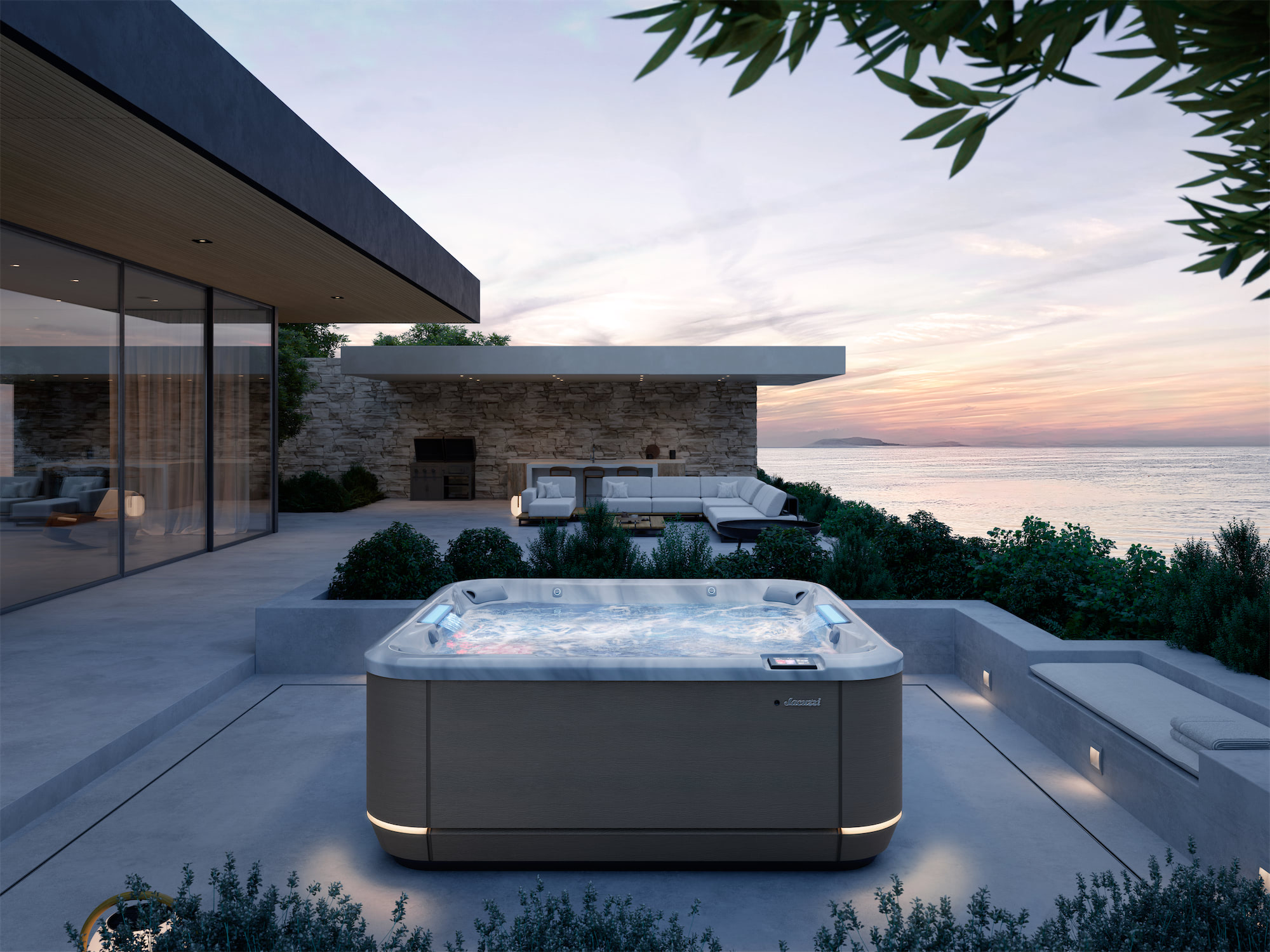 Modern terrace with a large outdoor hot tub overlooking the sea at sunset, glass walls and stone accents.